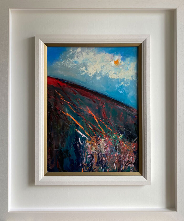a medley of colour in a white wood frame