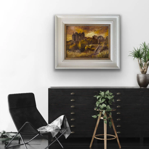 Golden Light Falling on Trim Castle painting positioned over a sideboard