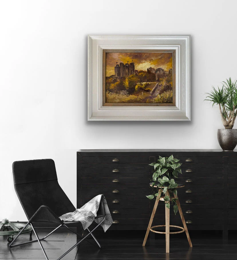 Golden Light Falling on Trim Castle painting positioned over a sideboard by Emily McCormack